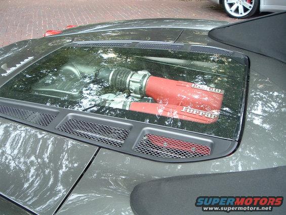 Ferrari engine intake system visible through glass engine cover