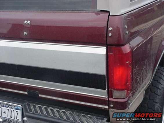 Maroon Ford Bronco rear quarter panel with chrome trim and a visible taillight