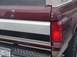 1996 Ford Bronco - The rear of a maroon Ford Bronco shows its distinctive body style and chrome accents.