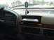 1996 Ford Bronco - Interior view of a vehicle's dashboard, an aftermarket stereo and hanging dog tags.