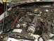 1985 Ford Crown Victoria LTD - The engine bay of a vehicle, showing the carburetor, distributor, and various hoses and wires.