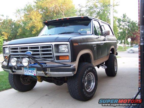 Lifted Ford Bronco with aftermarket bumper and lights. License plate PZE 405