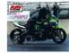 1999 Kawasaki H2C - A motorcycle with green and purple accents is seen in action, with a rider wearing a black helmet and leather suit. The image also features…