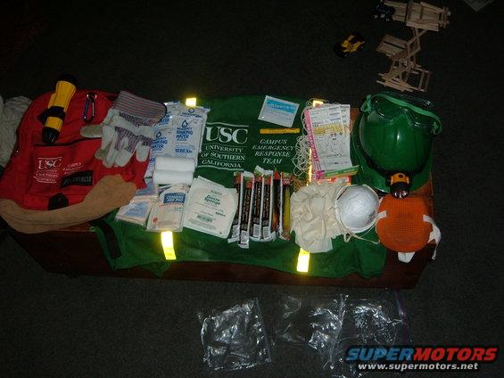 cert-gear.jpg C.E.R.T bag and gear includes a Backpack to carry all of this :
Flashlight, gloves, light sticks, water bags, first aid kit, hard hat with light, triage tags, whistle, goggles, dusk masks, Emergency personel vest. 
