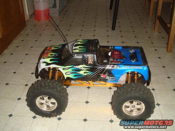 RC monster truck with flames and blue bed, says 'Wolverine' on side