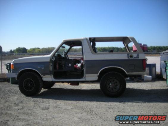 Side view of a two-tone 1991 Ford Bronco with doors removed