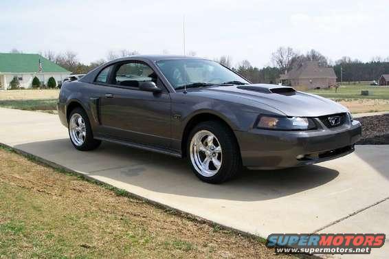 Dark gray 2003 Ford Mustang coupe with chrome wheels and hood scoop
