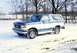 1990 Ford Bronco - A two-tone blue and white Ford Bronco sits in a snowy landscape during the winter.