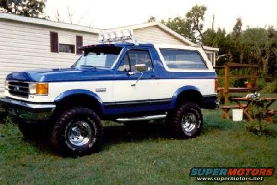 Blue and white 1990 Ford Bronco with roof lights