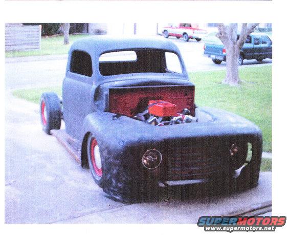 Unfinished 1948 Ford F-1 truck, matte black, red wheels, engine exposed