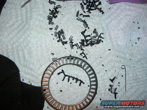 This is a bearing out of the t-case.  The black stuff is RTV.
