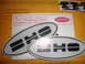 1990 Ford Taurus - Two silver oval badges with black lettering that spell out 'SHO'.