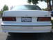 1990 Ford Taurus - Rear view of a white Ford Taurus SHO, a SHO Club license plate frame and 'SHO' badging on the bumper.