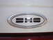 1990 Ford Taurus - Close-up of an oval SHO badge on a vehicle's exterior.