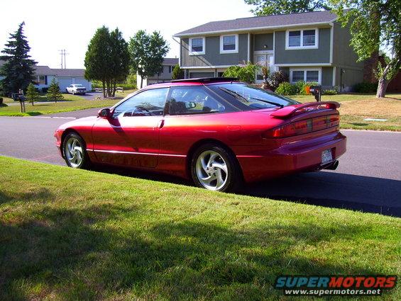 Red 1995 Ford Probe rear quarter view with spoiler and sunroof
