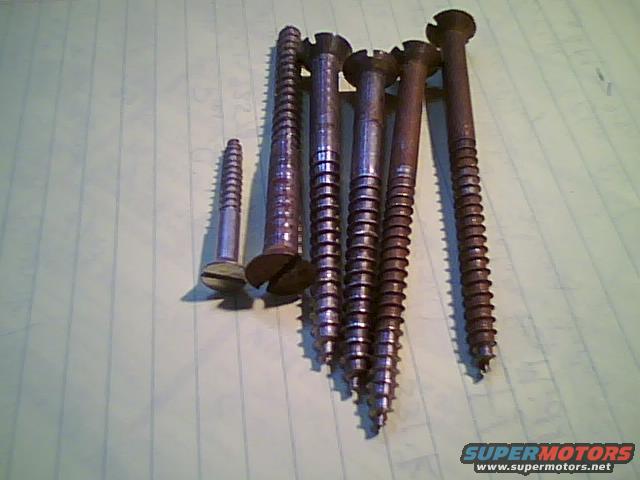 Assortment of wood screws of varying sizes on lined paper