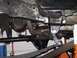 1991 Ford Bronco - Close-up of the undercarriage, focusing on the leaf spring and suspension mounting hardware.