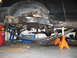 1991 Ford Bronco - Vehicle's rear axle and suspension components are visible, supported by jack stands.