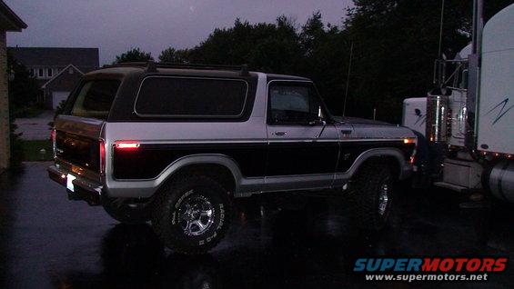 Ford Bronco parked next to a semi-truck