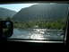 2007 Toyota FJ Cruiser - Sunlight sparkles on the water during a river crossing, with a mountain covered in white specks in the distance.