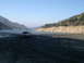 2007 Toyota FJ Cruiser - A pickup truck sits by a lake on a clear day, with mountains rising in the distance.