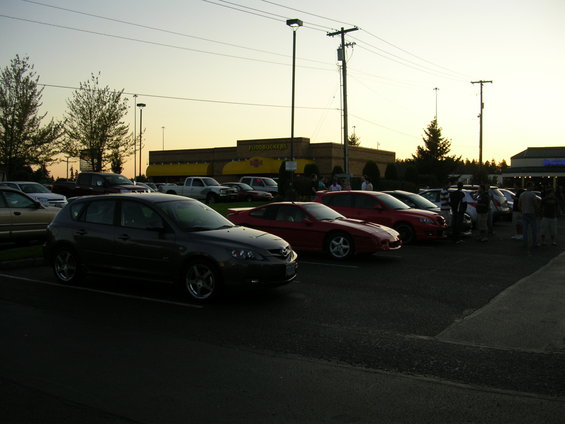 Dark gray 2007 Mazda 3 hatchback parked in a lot, front-left view