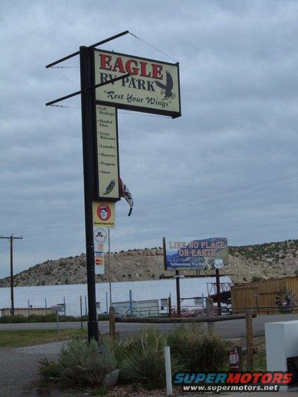 Sign for Eagle RV Park with list of amenities and tagline 'Rest Your Wings'