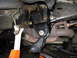 1991 Ford Bronco - Underbody view of vehicle suspension and frame components, with exhaust pipe visible.