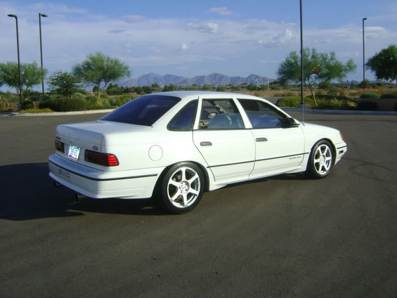 White 1993 Ford Taurus sedan parked on asphalt