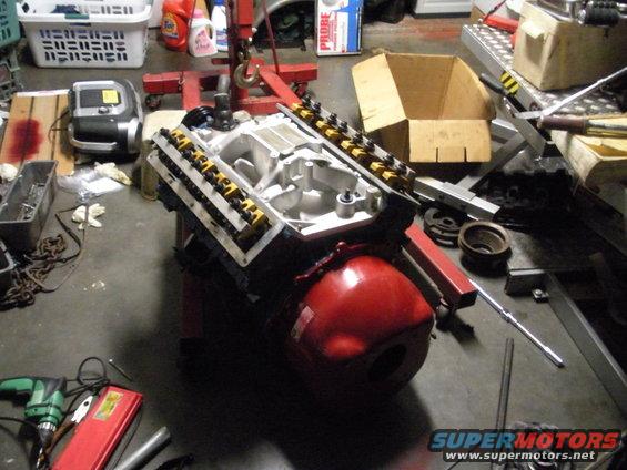 Engine on stand with red oil pan