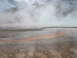 2006 Ford E350 - Steam rises from a colorful geothermal landscape with mineral deposits on the ground.