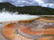 2006 Ford E350 - A geothermal hot spring emits steam, with vibrant mineral deposits creating patterns on the land's edge.