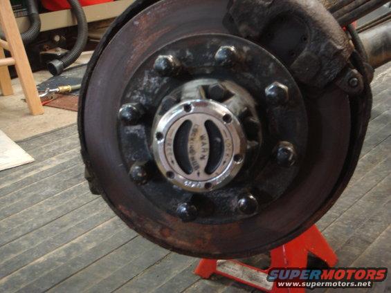 Close-up of a Warn locking hub on a vehicle's front wheel assembly