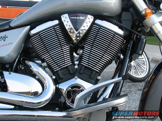 Victory motorcycle engine with V-twin cylinders and chrome exhaust pipes