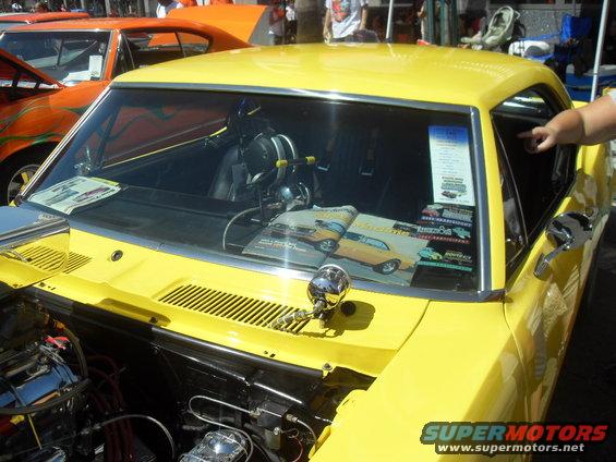 Yellow coupe with magazine on dashboard, showing a 1970s muscle car