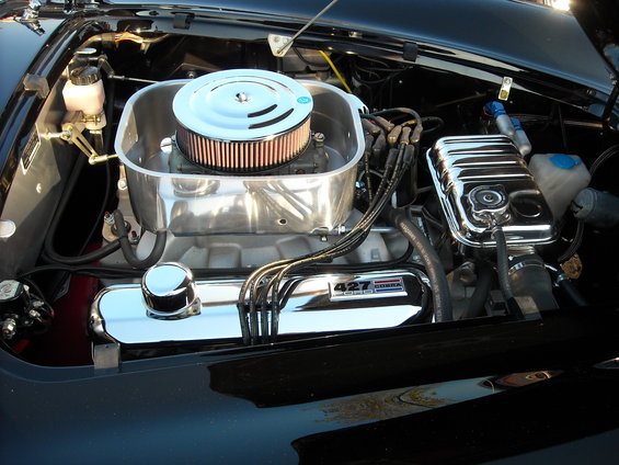 Engine bay with a chrome air cleaner and valve covers. "427 COBRA" is visible on a valve cover