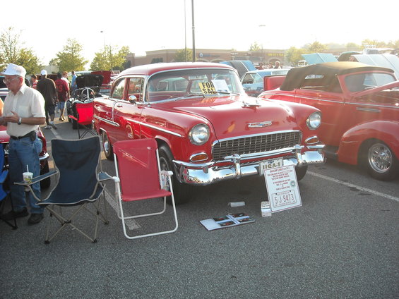 Red 1955 Chevrolet Bel Air with a "FOR SALE" sign in the window