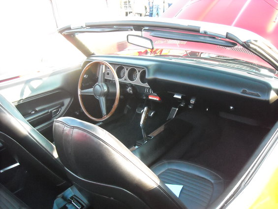 Interior view of a convertible with bucket seats and dashboard