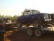 1992 Ford Bronco - A blue International Scout II is loaded onto a trailer, with another truck visible on a separate trailer behind it.