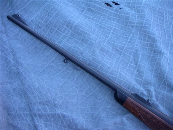 Rifle barrel and wooden stock with checkering