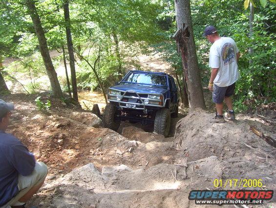 Blue SUV with custom bumper on rocky trail