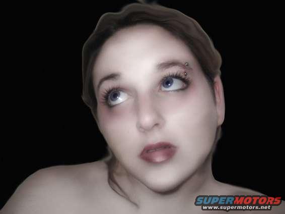 Woman with blue eyes and eyebrow piercing looking up