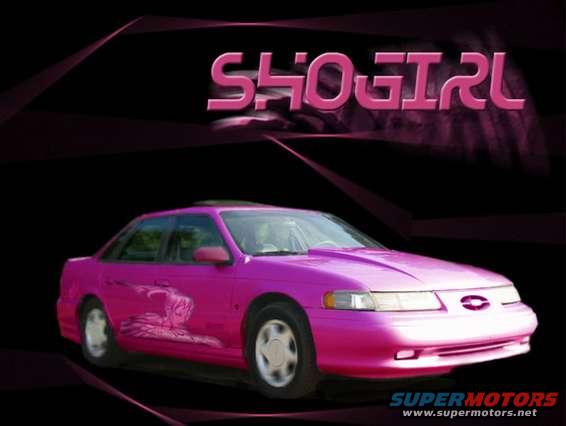 Pink sedan, possibly a 1994 Ford Taurus, with graphics on the side and "SHO GIRL" text above