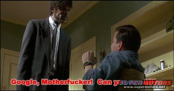 Man in a black suit stands over another man seated, with text overlay "Google, Motherfucker! Can you see Motors"