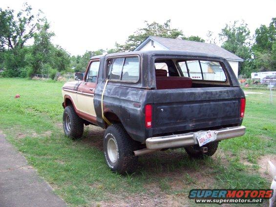 Rear view of a two-tone Ford Bronco with a black rear body and a brown/tan front