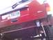 1998 Jeep Cherokee - The rear of a red 1998 Jeep Cherokee is shown with the bumper removed and a socket wrench attached to the frame.