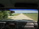 1985 Ford Bronco - Driving down a long, straight dirt road through agricultural fields, as seen from the driver's seat.