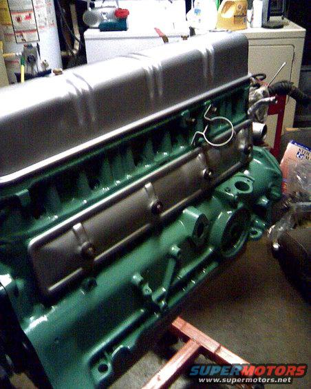 Green engine block with silver valve cover, engine view