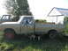 1971 International Travelall - A 1971 International Travelall pickup truck is parked outdoors next to a barn with another truck in the background.