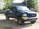 1971 International Travelall - This blue Ford F-250 pickup truck, seen from a 3/4 front angle, appears to be a 1999 model based on its grille design.